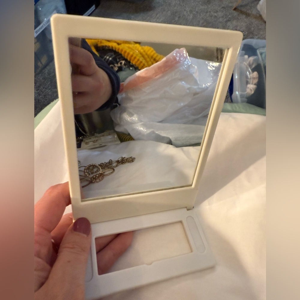Folding Travel-style mirror - I believe it also hold a photo on the other side